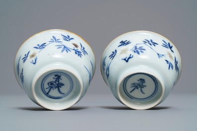 A pair of Chinese blue, white and underglaze red cups and saucers, Kangxi