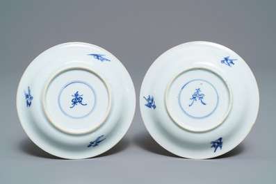 A pair of Chinese blue, white and underglaze red cups and saucers, Kangxi