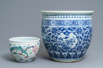 A Chinese blue and white fish bowl and a famille rose 'dragon' jardini&egrave;re, 19th C. and Yongzheng