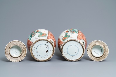 A pair of Chinese famille verte vases and covers, 19th C.