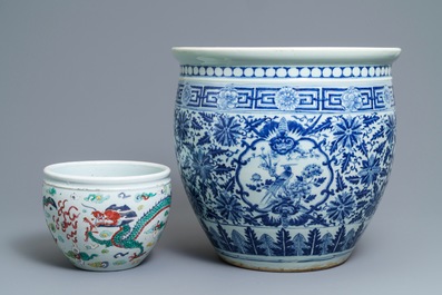 A Chinese blue and white fish bowl and a famille rose 'dragon' jardini&egrave;re, 19th C. and Yongzheng