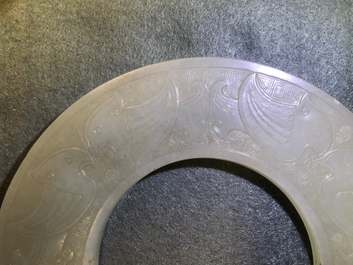 A Chinese pale celadon jade bi disc, Ming or earlier