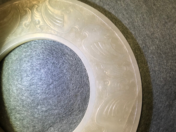 A Chinese pale celadon jade bi disc, Ming or earlier