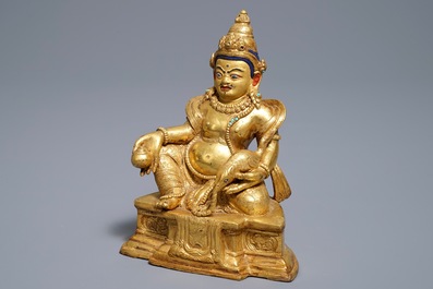 A Sino-Tibetan gilt bronze figure of Jambhala, 19/20th C.