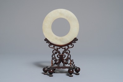 A Chinese pale celadon jade bi disc, Ming or earlier