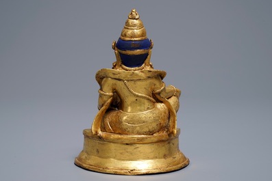 A Sino-Tibetan gilt bronze figure of Jambhala, 19/20th C.