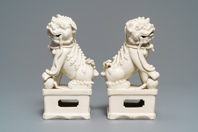 A pair of large Chinese Dehua blanc de Chine models of buddhist lions, Kangxi