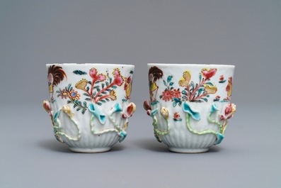 A pair of Chinese famille rose 'rooster' cups and saucers with applied floral designs, Yongzheng