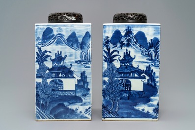 A pair of tall Chinese blue and white tea caddies with landscapes, 19th C.