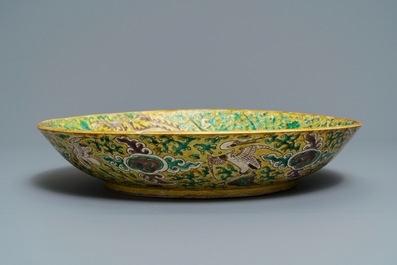 A Chinese green, yellow and aubergine-glazed biscuit 'phoenixes' dish, He He Jia Chan mark, Transitional period