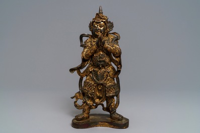 A Chinese gilt-lacquered bronze figure of Weituo, Ming