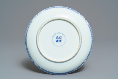 A Chinese blue and white plate with figures in a garden, Yongzheng