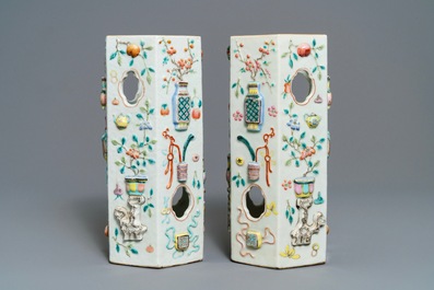 A pair of Chinese famille rose reticulated hat stands with applied designs, 19th C.