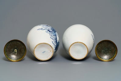 A pair of large Dutch Delft blue and white tobacco jars with brass covers, 18th C.