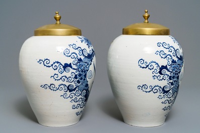 A pair of large Dutch Delft blue and white tobacco jars with brass covers, 18th C.