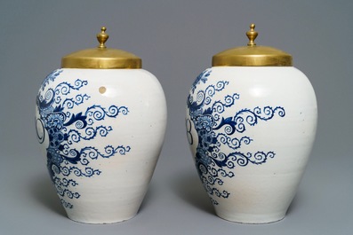 A pair of large Dutch Delft blue and white tobacco jars with brass covers, 18th C.