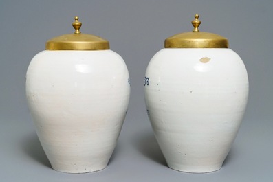 A pair of large Dutch Delft blue and white tobacco jars with brass covers, 18th C.