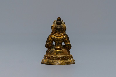 A Sino-Tibetan gilt bronze miniature figure of Buddha, 16/17th C.