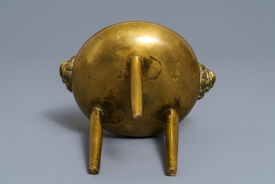 A Chinese bronze tripod censer with lion head handles, 19/20th C.