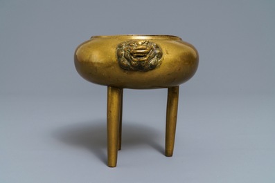 A Chinese bronze tripod censer with lion head handles, 19/20th C.