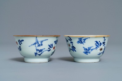 A pair of Chinese blue, white and underglaze red cups and saucers, Kangxi