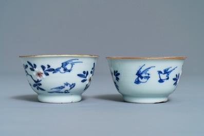 A pair of Chinese blue, white and underglaze red cups and saucers, Kangxi