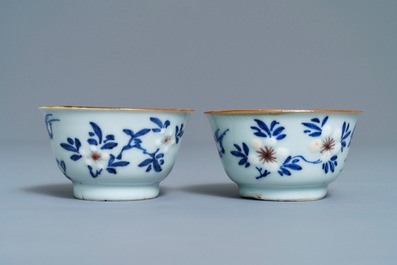 A pair of Chinese blue, white and underglaze red cups and saucers, Kangxi