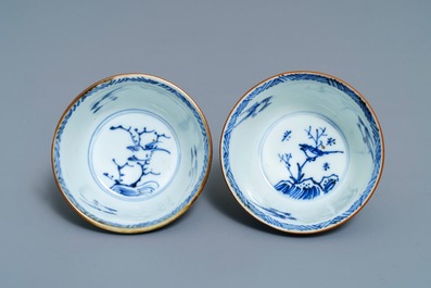 A pair of Chinese blue, white and underglaze red cups and saucers, Kangxi