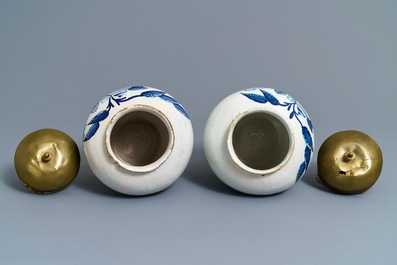 A pair of Dutch Delft blue and white tobacco jars with native American indians, 18th C.