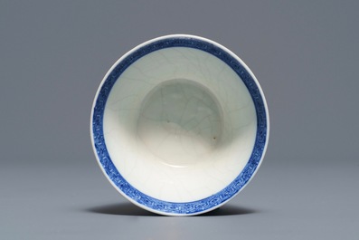 A Chinese blue and white 'soft paste' cup and saucer with an unusual scene with slaves, Qianlong