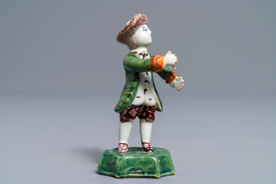 A polychrome Dutch Delft figure of a boy with a hat, 18th C.