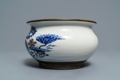 A Chinese blue, white and underglaze red censer, a wall pocket vase and a monochrome blue vase, 19/20th C.