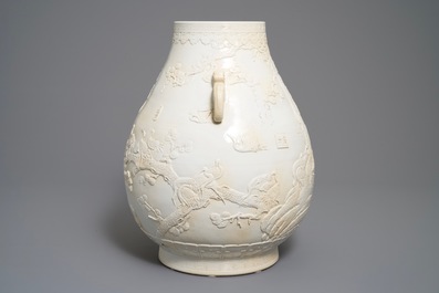 A Chinese monochrome cream-glazed relief-decorated hu vase, Qianlong mark, 20th C.