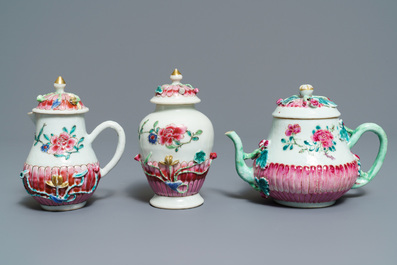 A Chinese famille rose relief-decorated teapot, milk jug and tea caddy on stands, Yongzheng