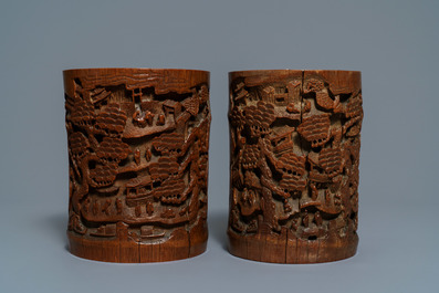 Two Chinese carved bamboo brush pots and five wooden stands, 19/20th C.