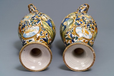 A pair of massive Italian maiolica ewers with figures in landscapes, 19th C.