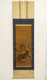 Japanese school, 18/19th C., after Kano Masanobu, ink on silk: A tiger on a rock