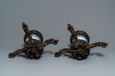 A Dutch Delft blue and white three-piece garniture with carved wooden candleholders, 18th C.