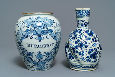 A Dutch Delft blue and white tobacco jar, a jug and three dishes, 18th C.