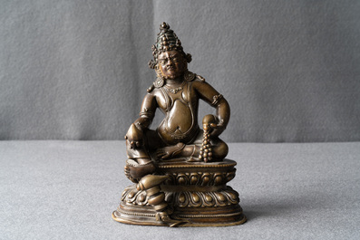 A Sino-Tibetan bronze figure of Jambhala, 17/18th C.