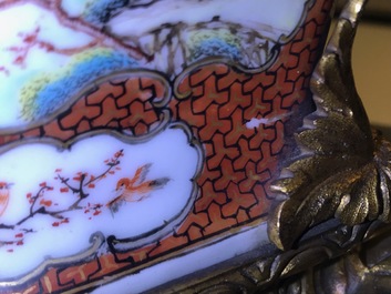 Une paire de vases en porcelaine de Chine famille rose &agrave; d&eacute;cor mandarin aux montures en bronze dor&eacute;, Qianlong