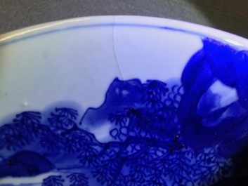 A Chinese blue and white plate with travellers in a landscape, Kangxi mark and of the period