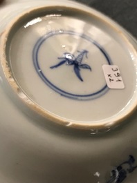 A pair of Chinese blue, white and underglaze red cups and saucers, Kangxi