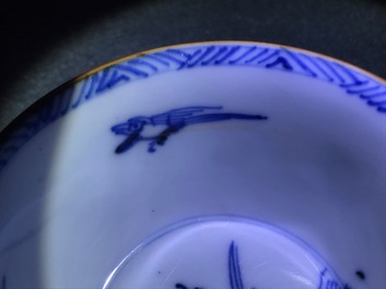 A pair of Chinese blue, white and underglaze red cups and saucers, Kangxi