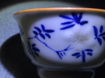 A pair of Chinese blue, white and underglaze red cups and saucers, Kangxi