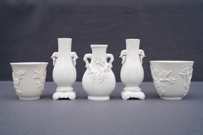 Three Chinese blanc de Chine vases and two cups with applied designs, Kangxi and later