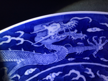 A Chinese blue and white reverse-decorated 'dragon' dish, Daoguang mark and prob. of the period