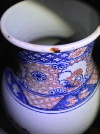 A Chinese blue, white and underglaze red landscape vase, 19th C.