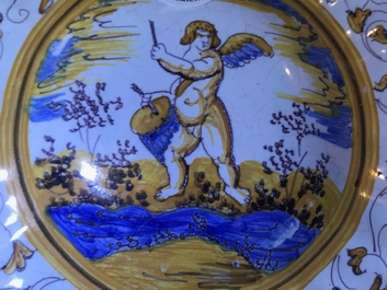 Een gelobde majolica schotel op voet met een putto tussen grotesken, atelier Willem Jansz Verstraeten, Haarlem, ca. 1650