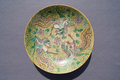 A Chinese green, yellow and aubergine-glazed biscuit 'phoenixes' dish, He He Jia Chan mark, Transitional period